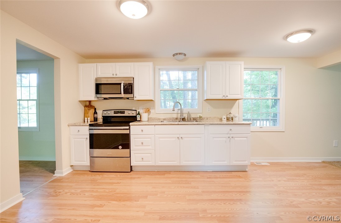 9302 Radborne Road Chesterfield, VA 23236 - Photo 2 of 48 a kitchen with granite countertop a stove a sink and a microwave