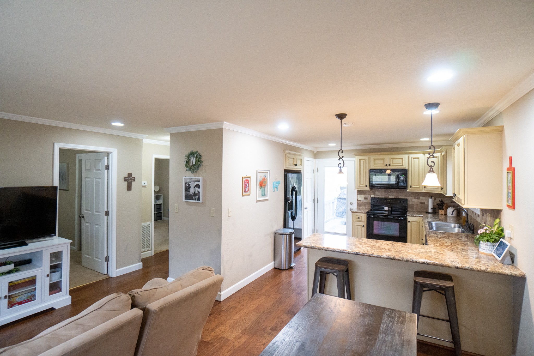 202 Airport Road Portland, TN 37148 - Photo 5 of 38 a living room with furniture a flat screen tv and kitchen view