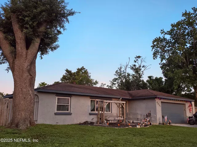 a front view of house with yard barbeque and outdoor seating
