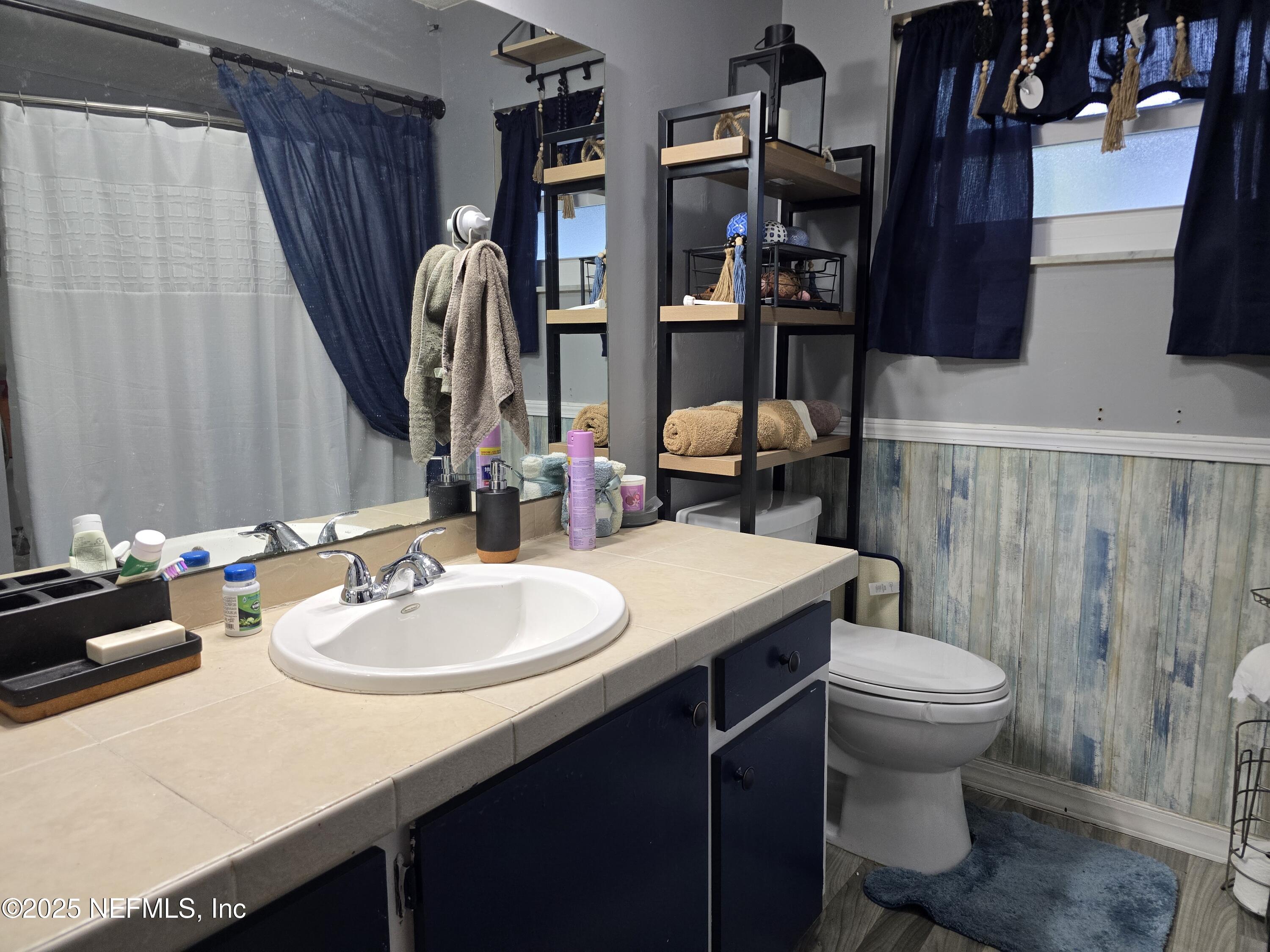6051 Foxfire Court Jacksonville, FL 32244 - Photo 13 of 31 a bathroom with a sink toilet and shower