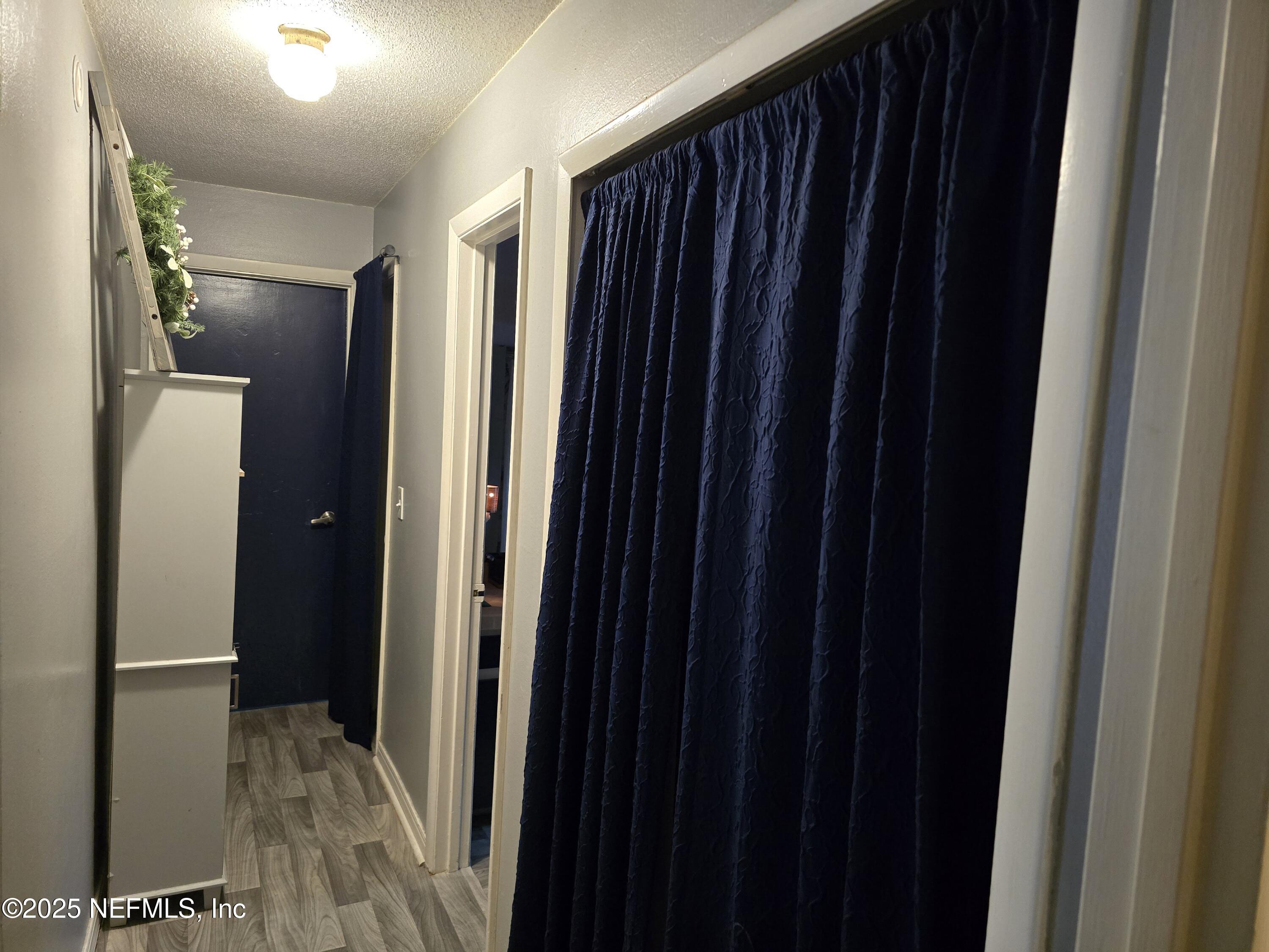 6051 Foxfire Court Jacksonville, FL 32244 - Photo 18 of 31 a view of a hallway with wooden floor
