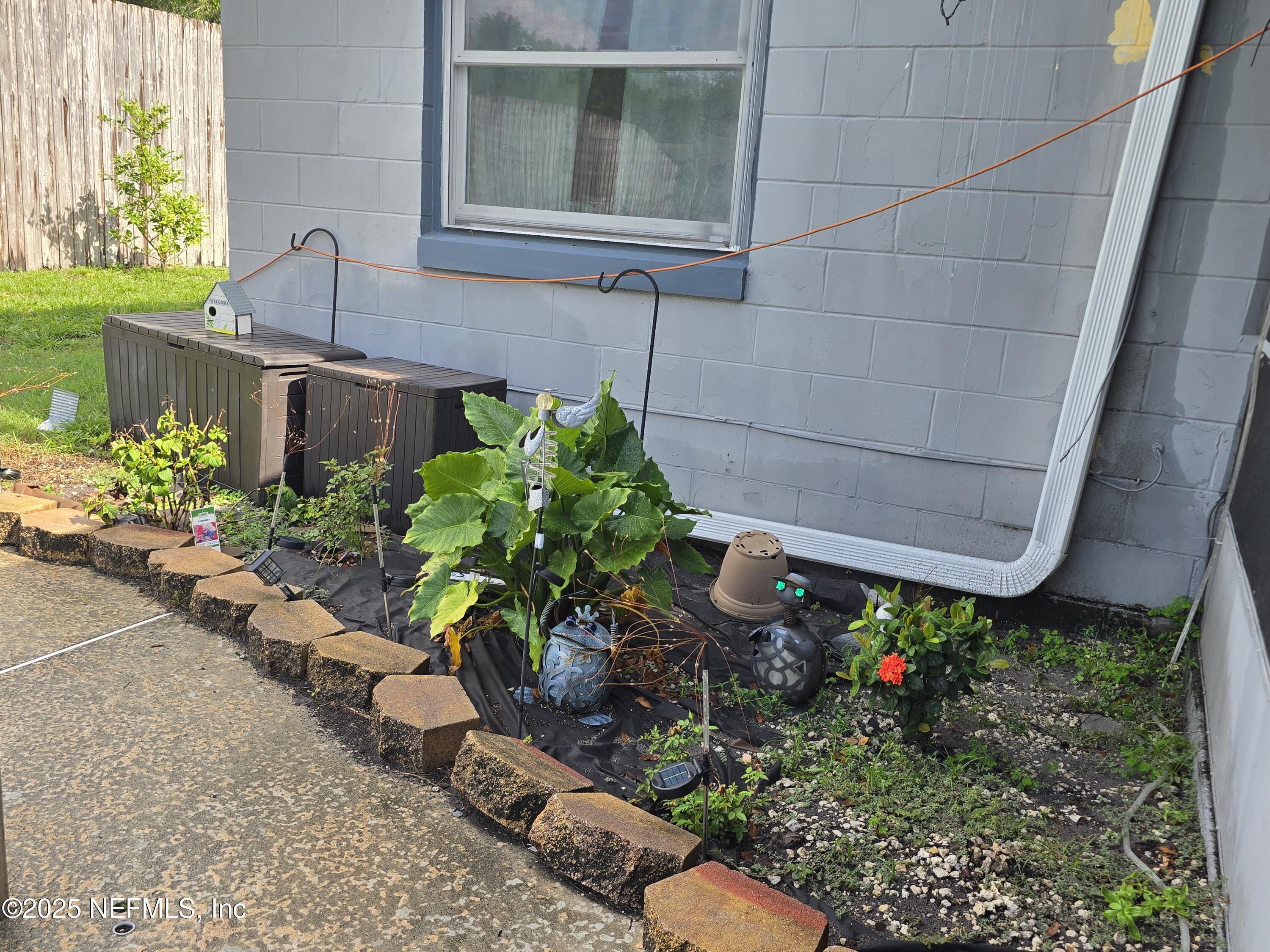6051 Foxfire Court Jacksonville, FL 32244 - Photo 20 of 31 a potted plant sitting in front of a house
