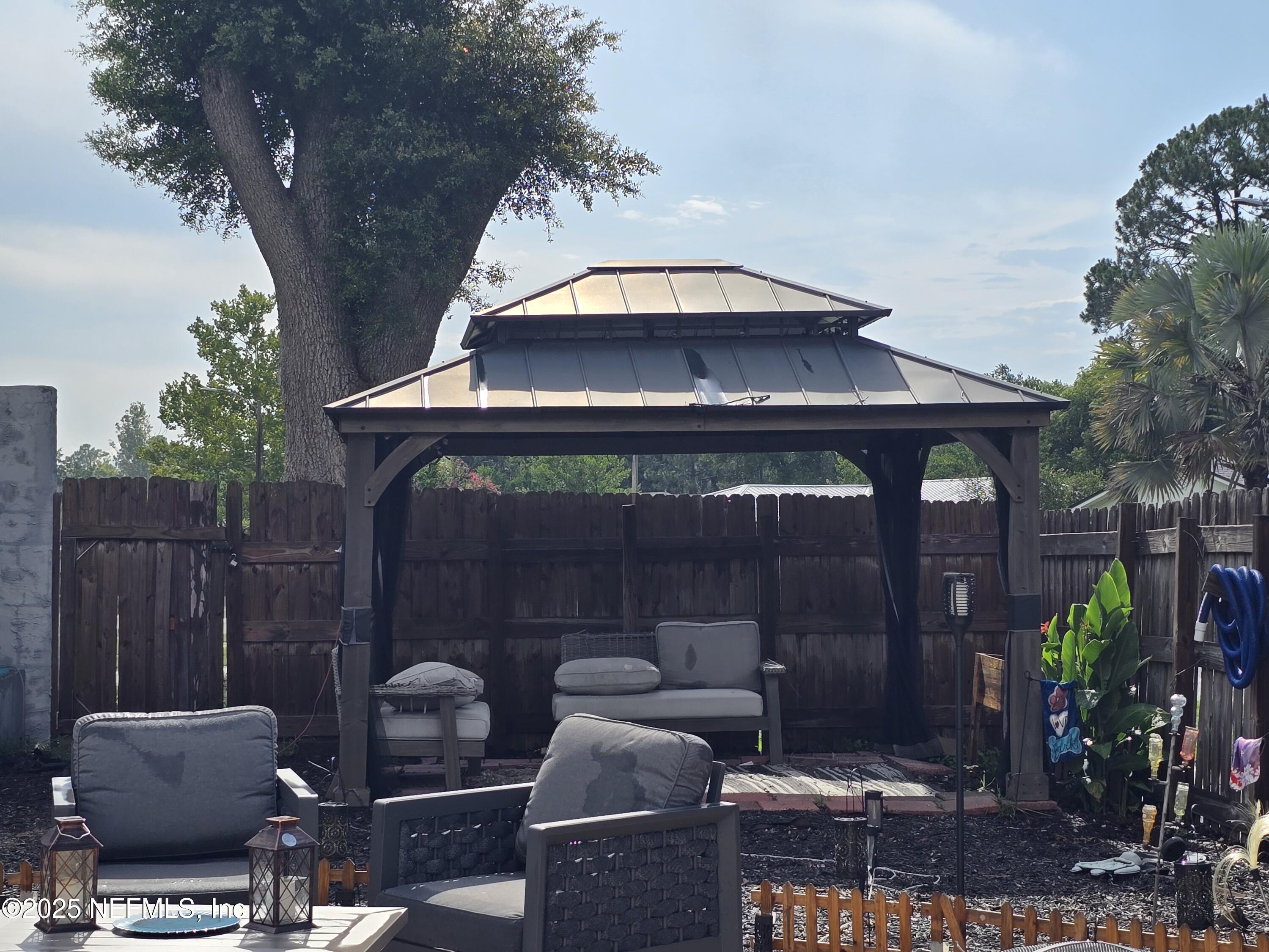 6051 Foxfire Court Jacksonville, FL 32244 - Photo 21 of 31 a view of a chairs and tables in the back yard of the house