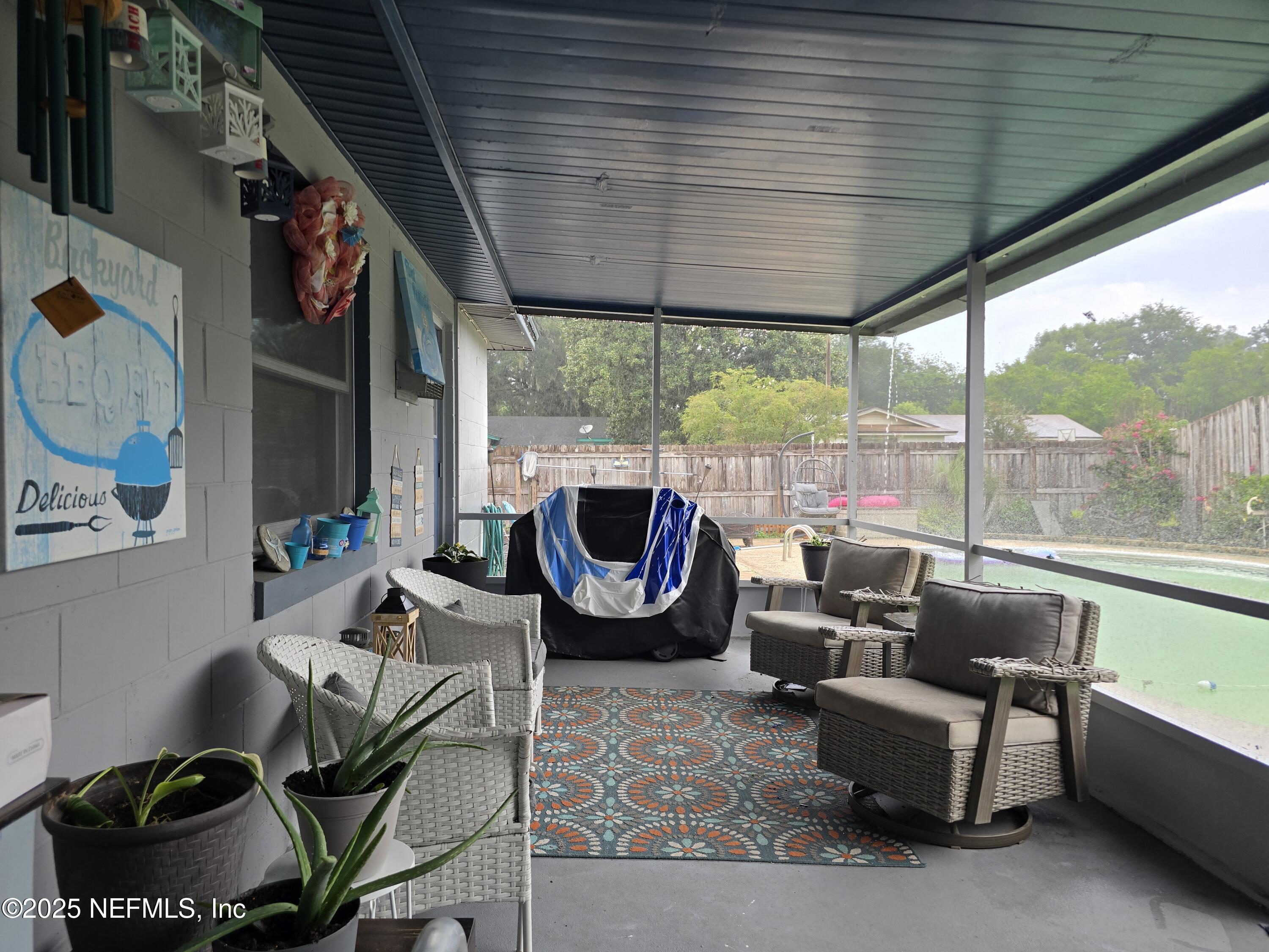6051 Foxfire Court Jacksonville, FL 32244 - Photo 25 of 31 a living room with furniture and a large window