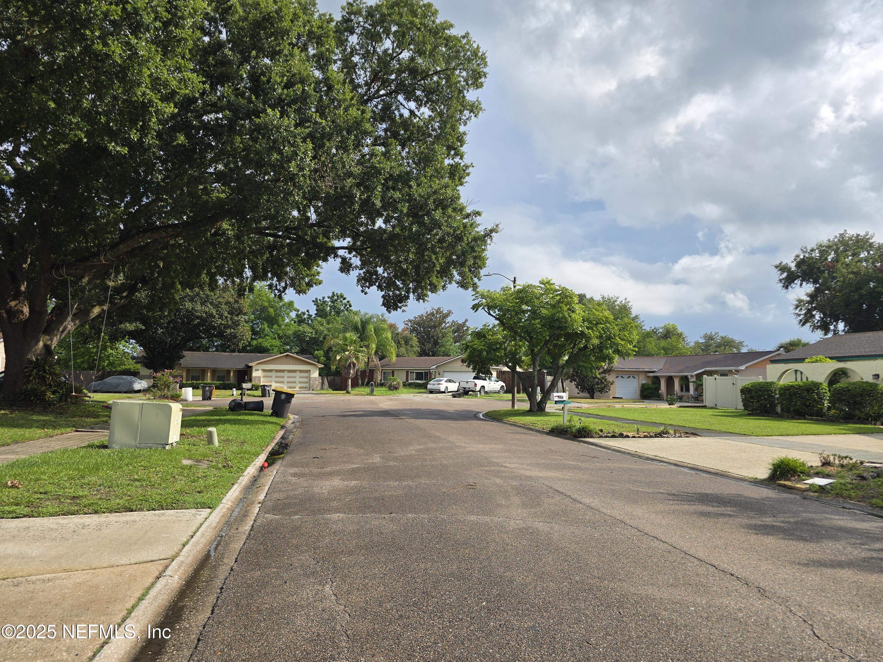 6051 Foxfire Court Jacksonville, FL 32244 - Photo 30 of 31 a view of a street with a houses and a street view