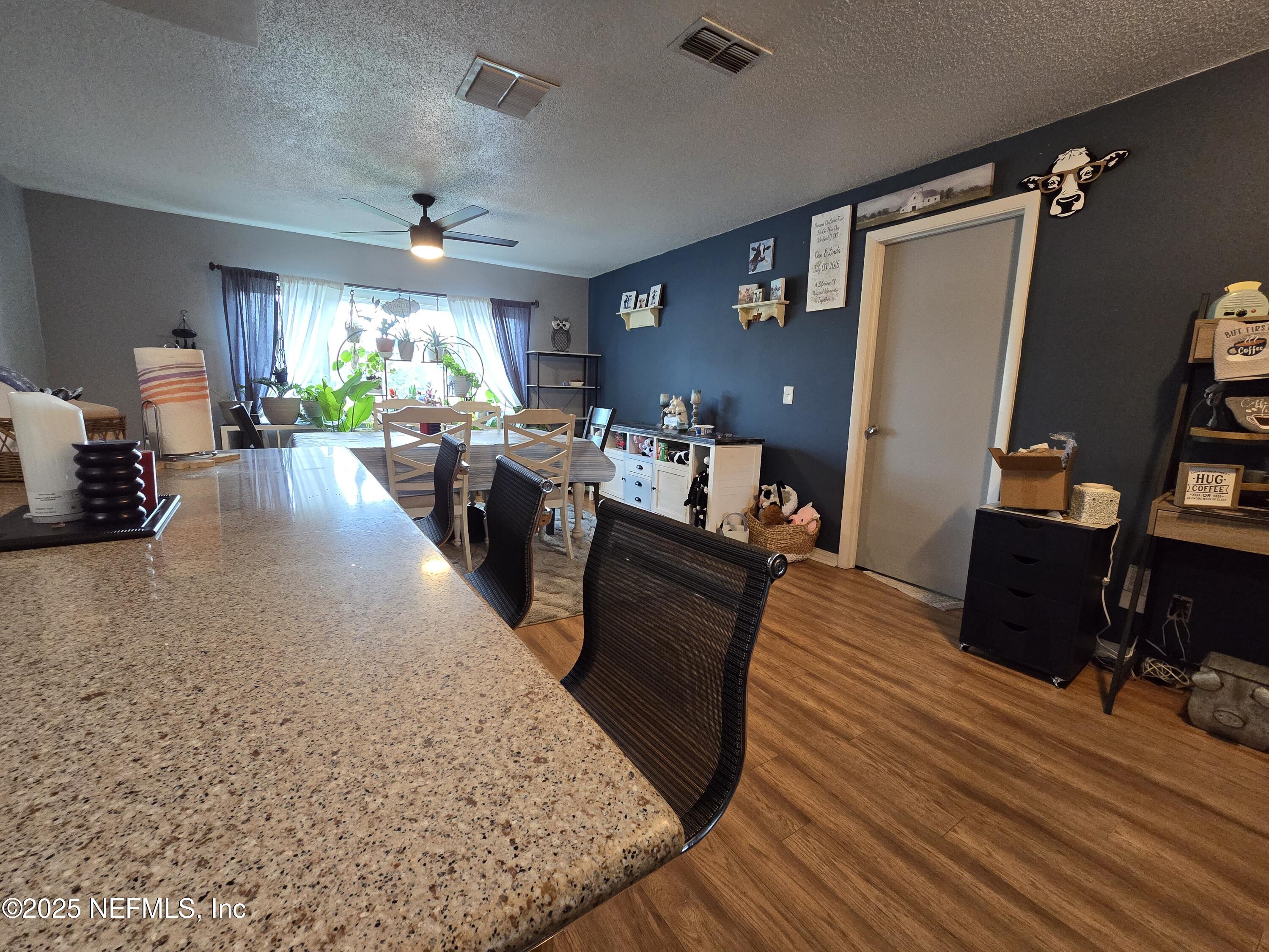 6051 Foxfire Court Jacksonville, FL 32244 - Photo 6 of 31 a living room with furniture and a flat screen tv