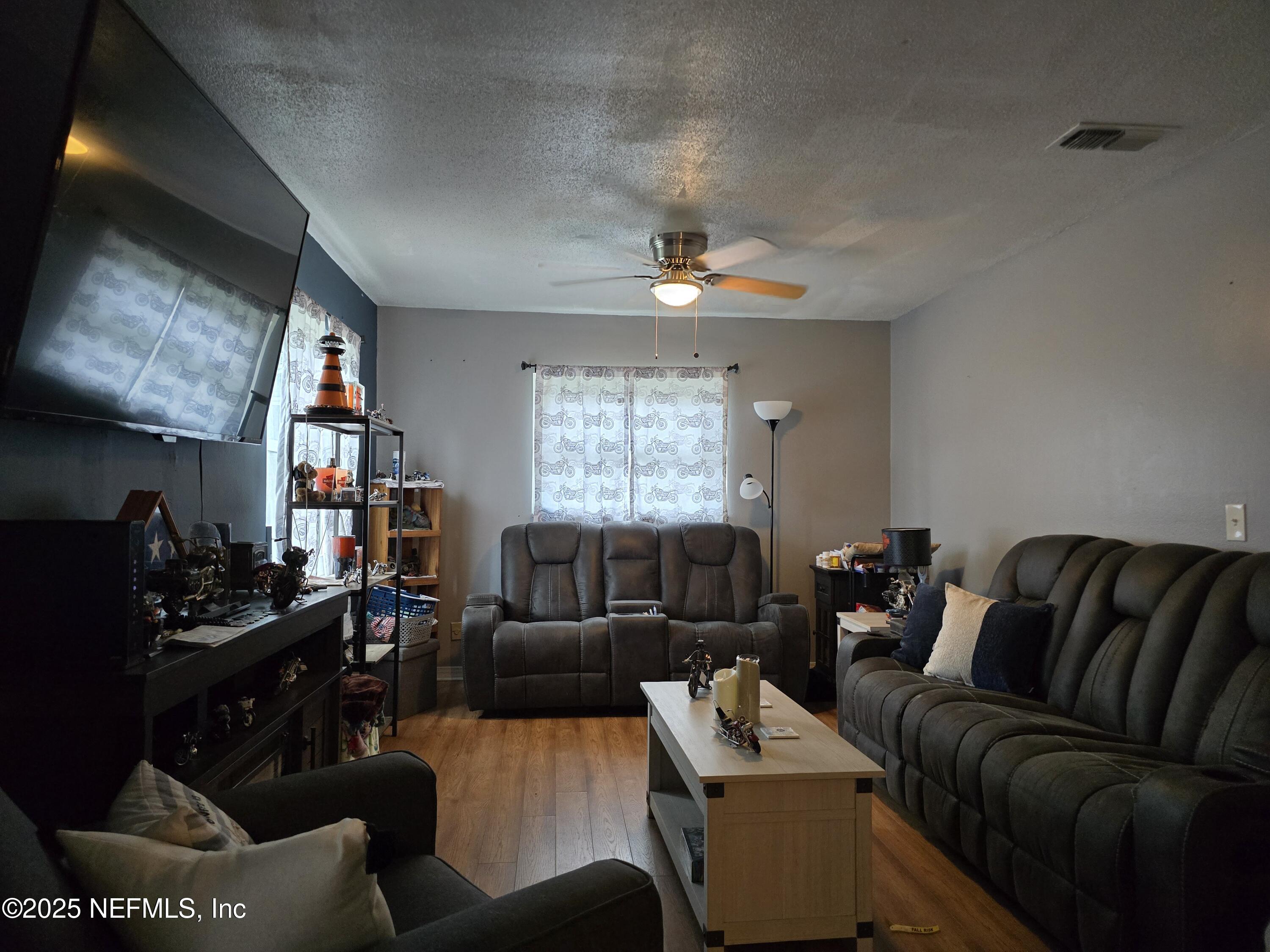 6051 Foxfire Court Jacksonville, FL 32244 - Photo 7 of 31 a living room with furniture ceiling fan and a window
