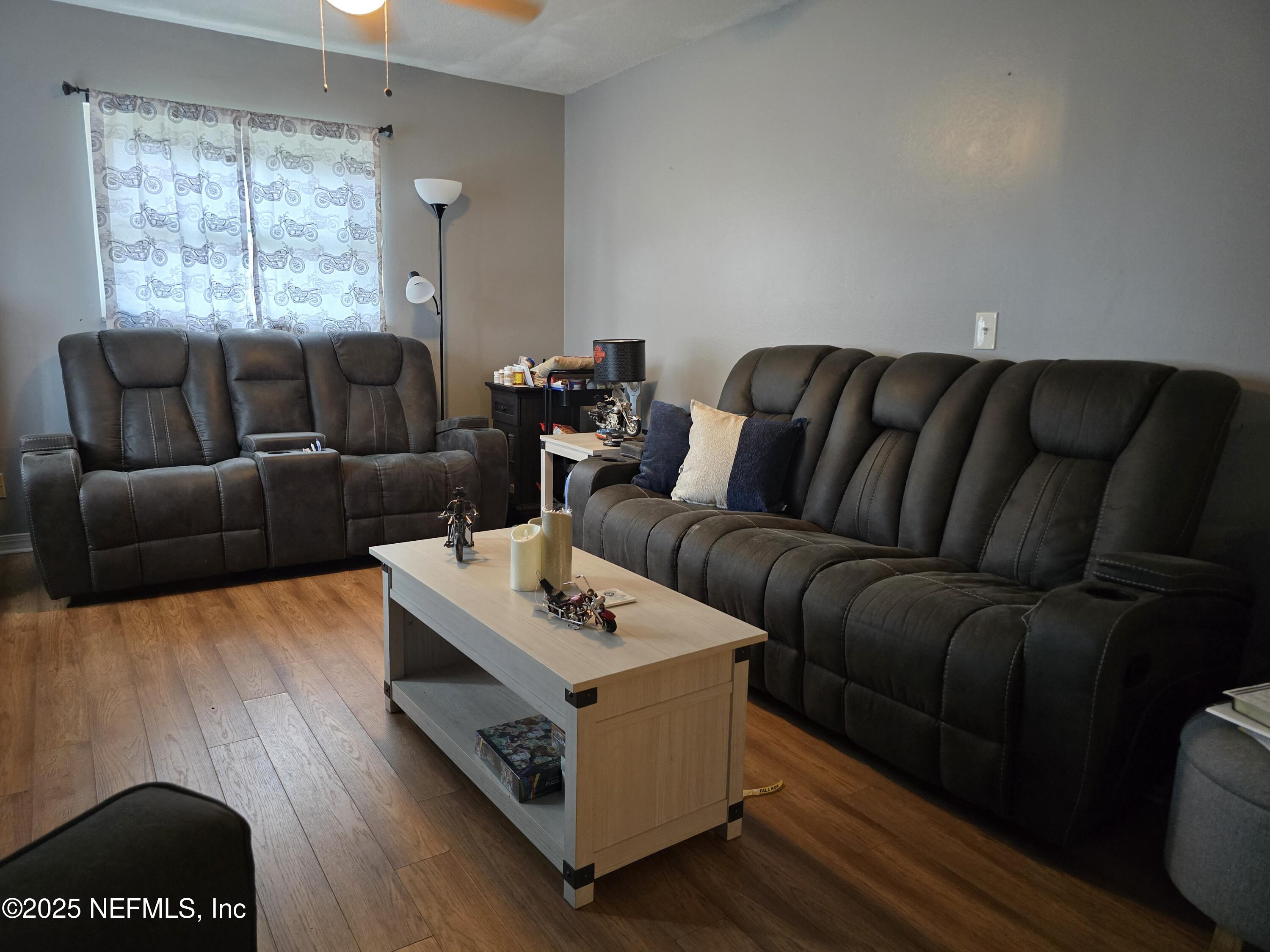 6051 Foxfire Court Jacksonville, FL 32244 - Photo 10 of 31 a living room with furniture and a window
