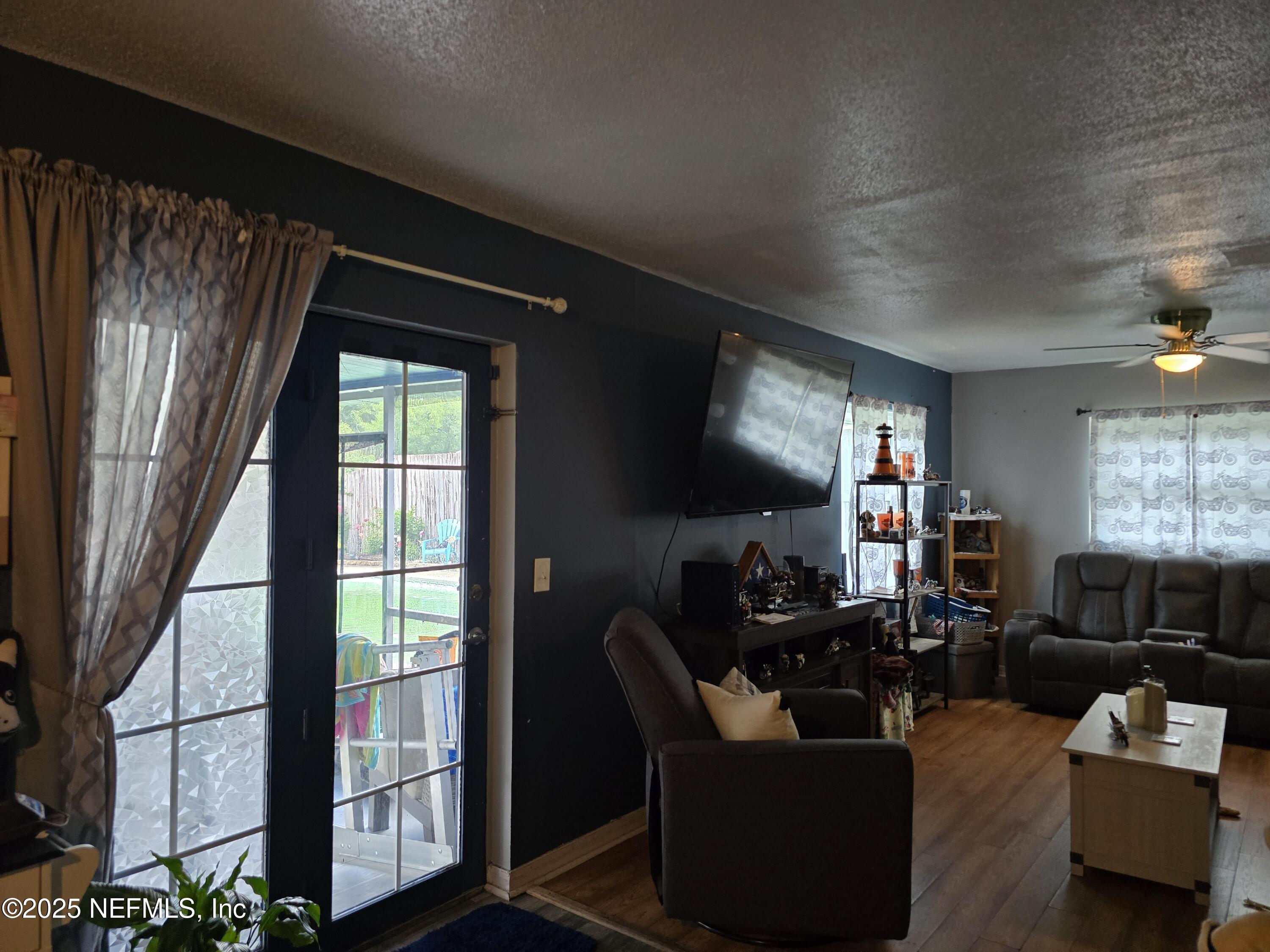 6051 Foxfire Court Jacksonville, FL 32244 - Photo 10 of 31 a living room with furniture and a flat screen tv