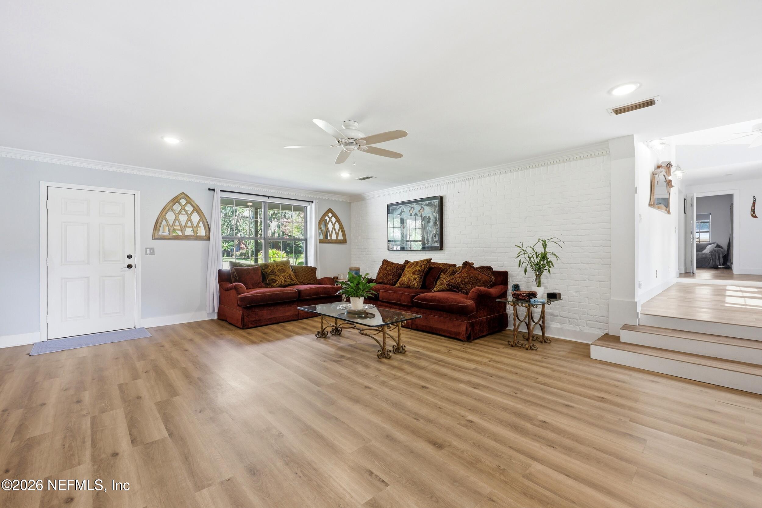 11627 Mandarin Terrace Road Jacksonville, FL 32223 - Photo 28 of 79 a living room with furniture and a wooden floor