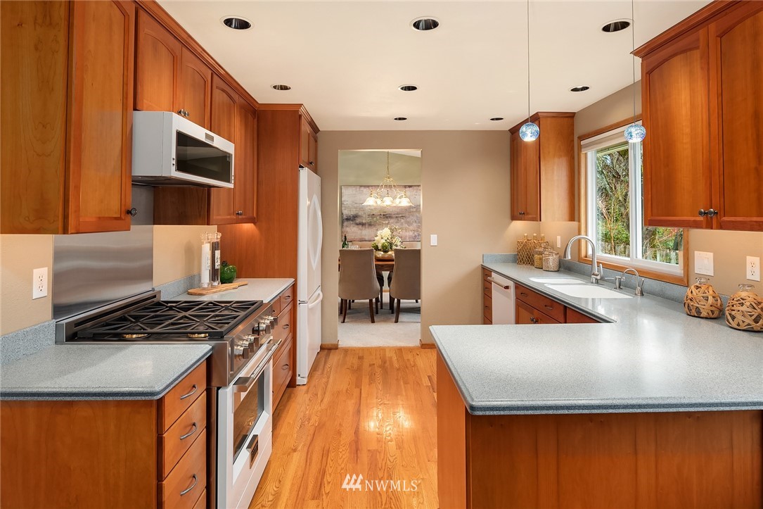 1133 South 23rd Street Renton, WA 98055 - Photo 11 of 38 a kitchen with stainless steel appliances granite countertop a stove and a sink