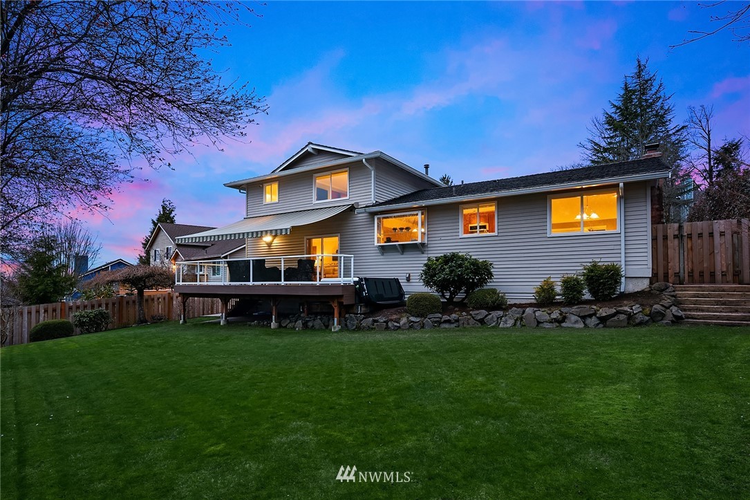 1133 South 23rd Street Renton, WA 98055 - Photo 16 of 38 a front view of a house with a garden and deck