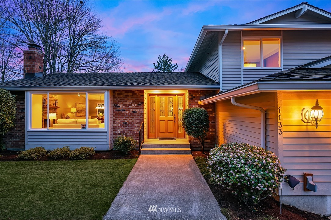 1133 South 23rd Street Renton, WA 98055 - Photo 2 of 38 a front view of a house with a yard and potted plants