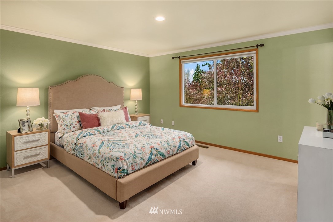 1133 South 23rd Street Renton, WA 98055 - Photo 22 of 38 a large bed sitting in a bedroom next to a lamp