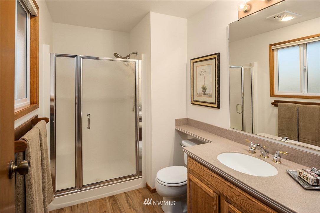 1133 South 23rd Street Renton, WA 98055 - Photo 23 of 38 a bathroom with a granite countertop toilet sink and a mirror