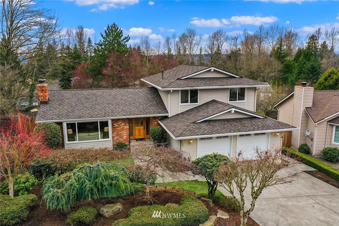 1133 South 23rd Street Renton, WA 98055 - Photo 3 of 38 a front view of a house with a yard and mountain view in back