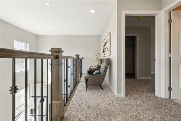 a view of hallway with furniture and windows