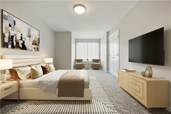 a bedroom with a large bed and a flat screen tv
