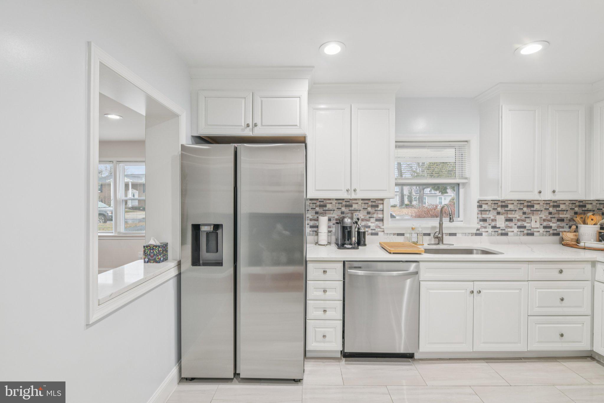 303 Foundry Lane Fort Washington, MD 20744 - Photo 12 of 43 a kitchen with white cabinets and stainless steel appliances