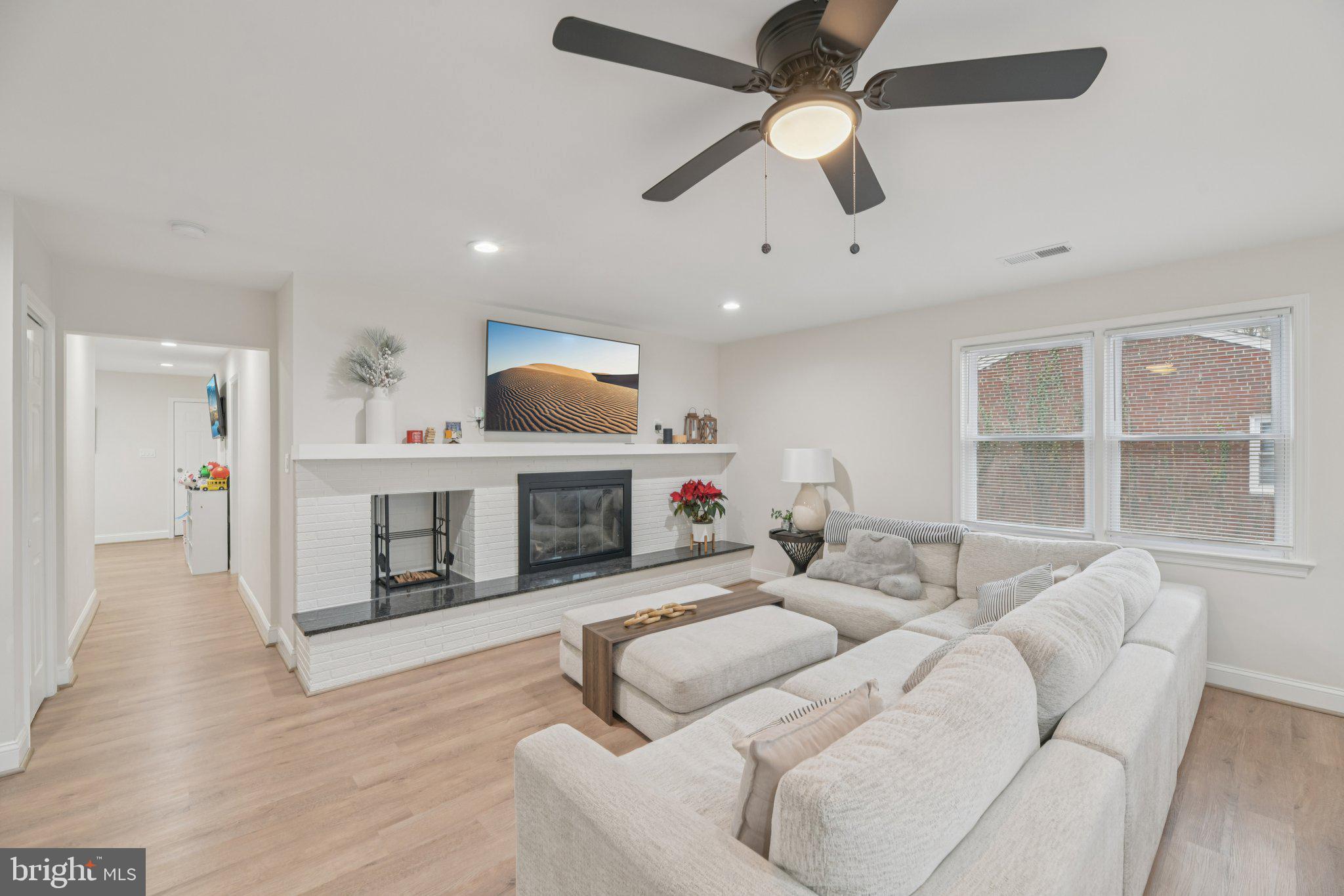 303 Foundry Lane Fort Washington, MD 20744 - Photo 3 of 43 a living room with furniture a fireplace and a flat screen tv
