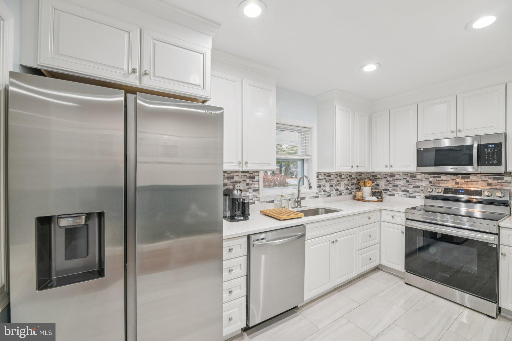 303 Foundry Lane Fort Washington, MD 20744 - Photo 9 of 43 a kitchen with a sink stainless steel appliances and cabinets