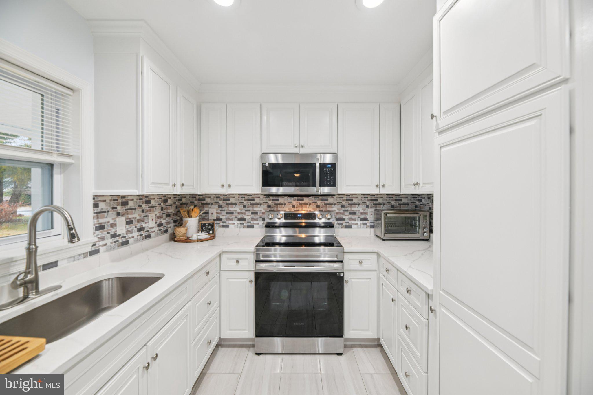 303 Foundry Lane Fort Washington, MD 20744 - Photo 10 of 43 a kitchen with cabinets stainless steel appliances and a sink