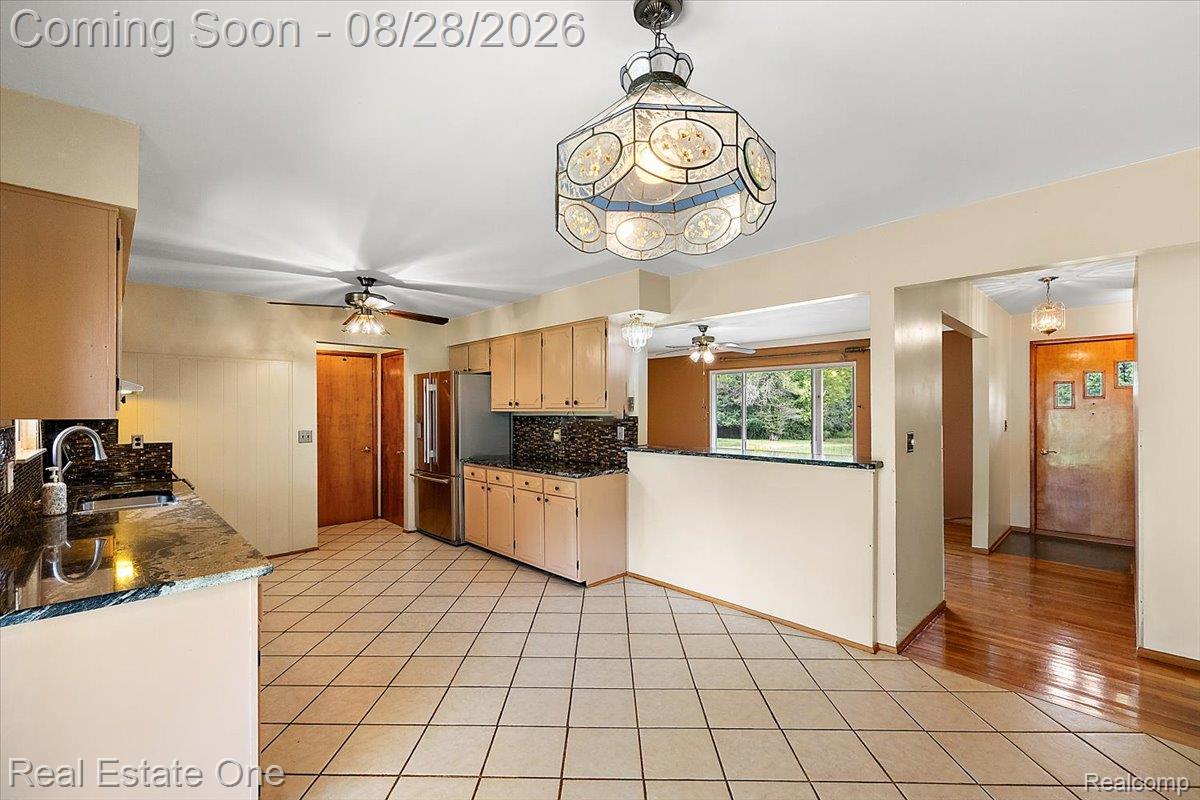 15250 34 Mile Road Armada, MI 48005 - Photo 29 of 49 Kitchen featuring tile flooring, neutral cabinetry, dark countertops, and a full suite of stainless steel appliances