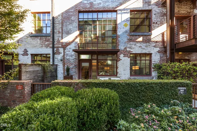 a view of a brick building next to a yard