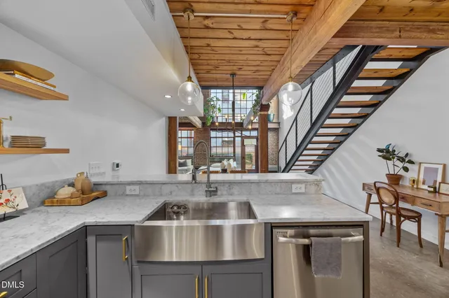 a kitchen with stainless steel appliances wooden cabinets a stove and a refrigerator