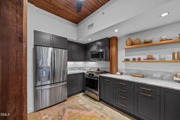 a kitchen with a sink stove and microwave