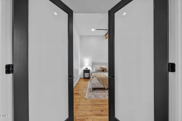 a view of entryway with a front door and wooden floor