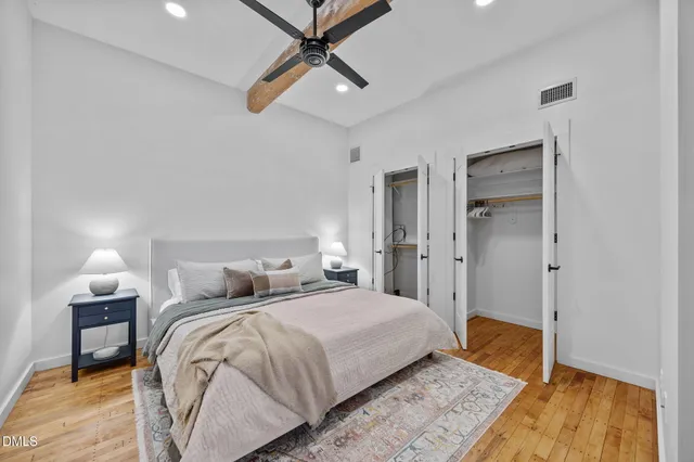 a bedroom with a bed and a lamp