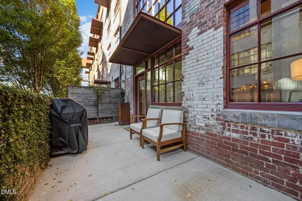 a building outdoor space with patio furniture and potted plants