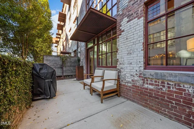 a building outdoor space with patio furniture and potted plants