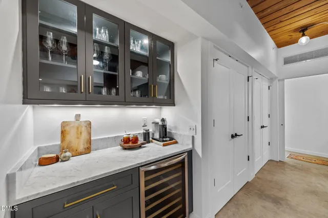 a kitchen with a table chairs refrigerator and cabinets