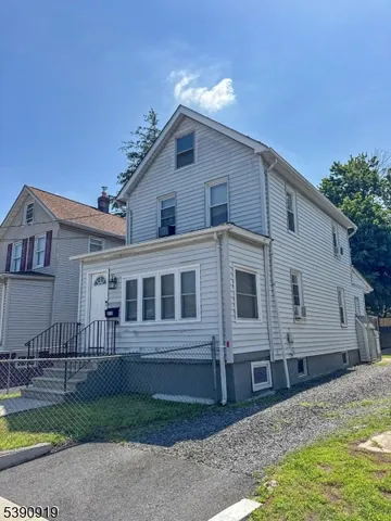 a view of a house with wooden fence