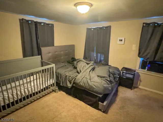 a bed sitting in a bedroom next to a window