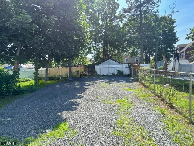 a view of a house with backyard and tree