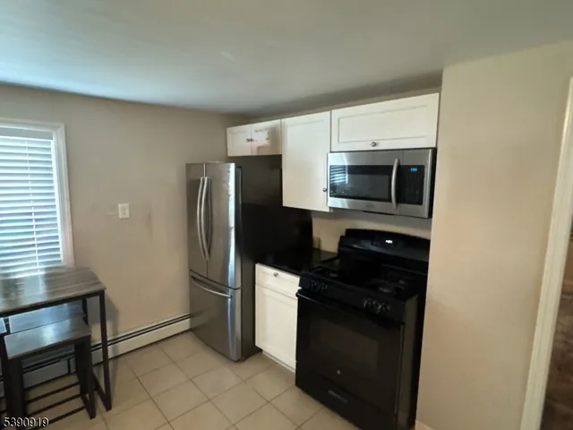 a kitchen with a refrigerator stove and microwave