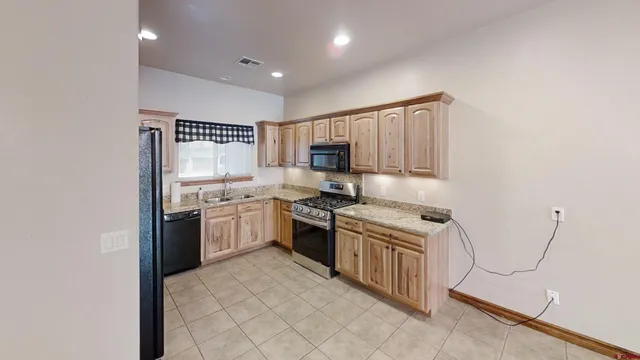 a kitchen with a stove top oven sink and cabinets