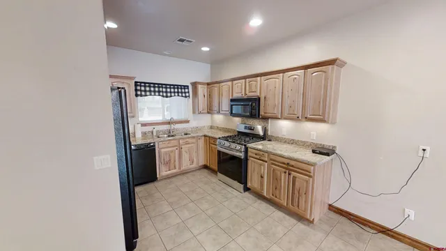 a kitchen with a stove top oven sink and cabinets