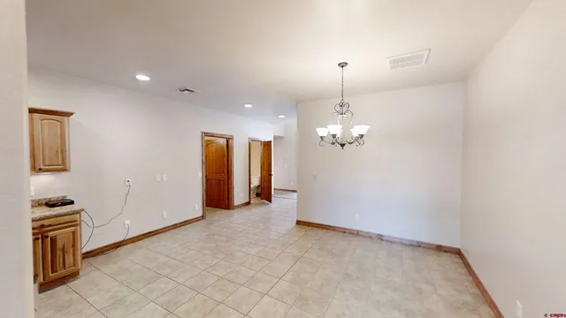 a view of a livingroom with a chandelier fan