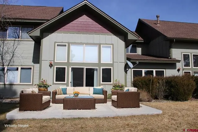 a view of house with yard in front of it