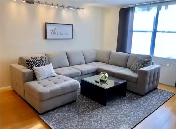 a living room with furniture rug and window