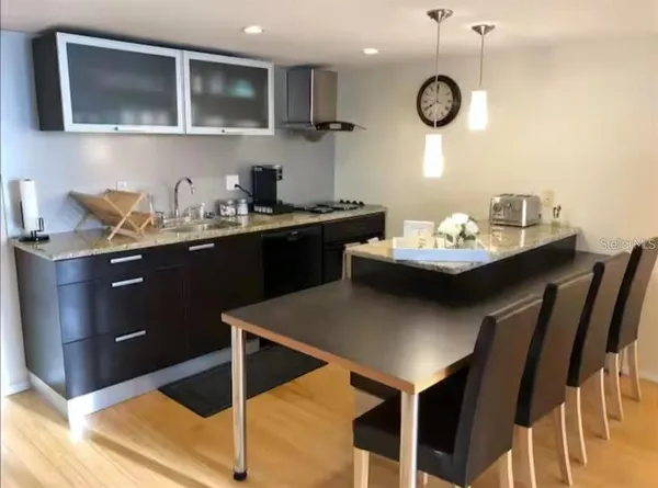 a kitchen with a dining table and chairs