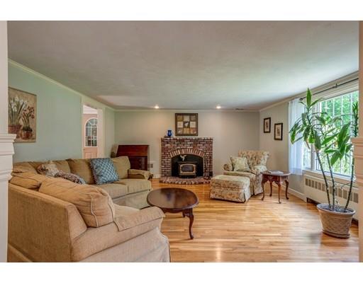 25 Woodside Road Topsfield, MA 01983 - Photo 4 of 37 a living room with furniture a fireplace and a large window