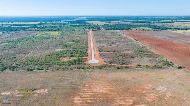 a view of a field with an ocean