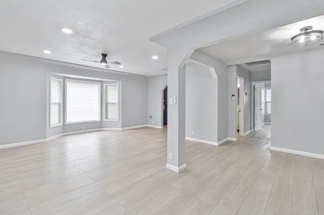 a view of a livingroom with wooden floor and window