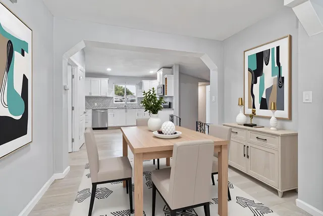a dining room with furniture and window