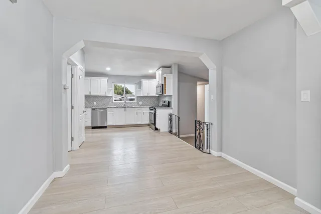 a large kitchen with a refrigerator and a stove top oven
